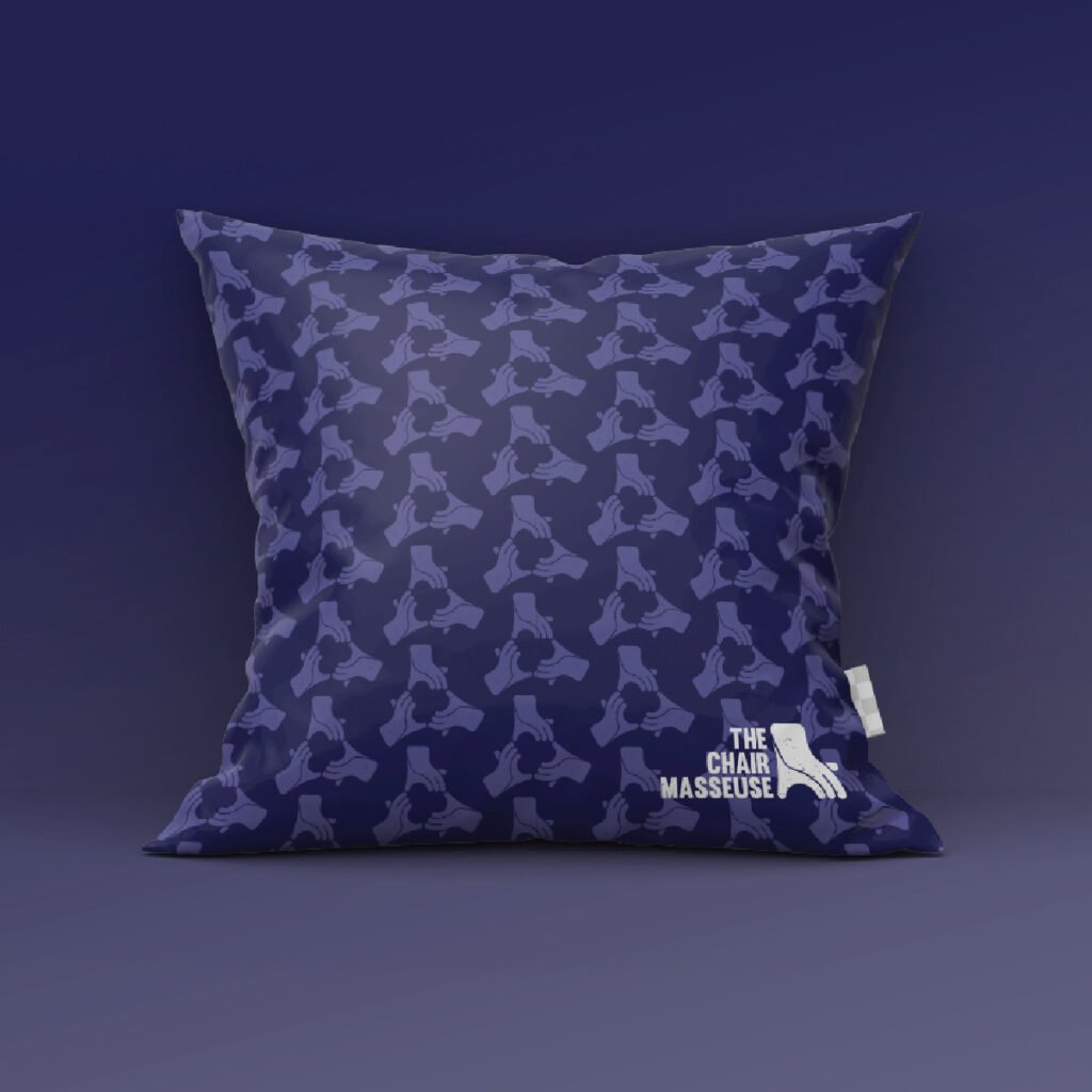 The Chair Masseuse branded pillow with repeating logo pattern